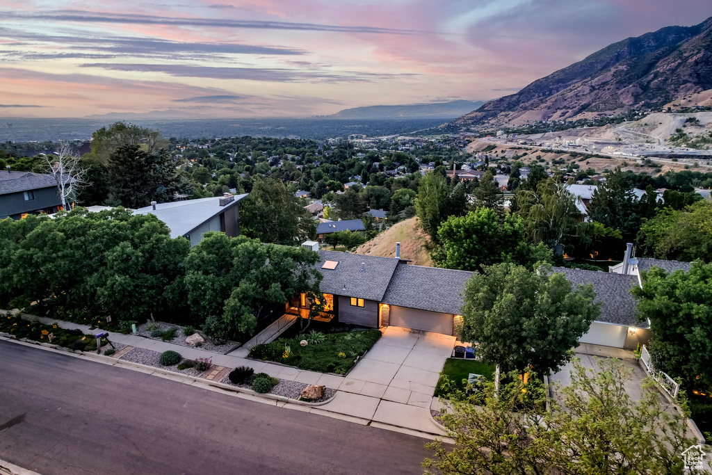 Aerial view of property and surrounding area featuring a mountain backdrop