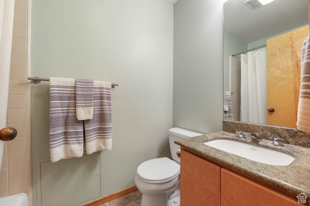 Bathroom featuring vanity and curtained shower