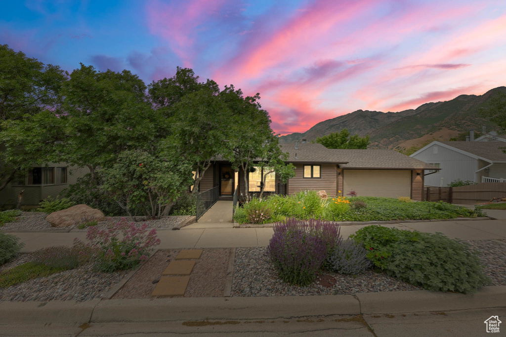 View of front of home featuring a mountain view and an attached garage