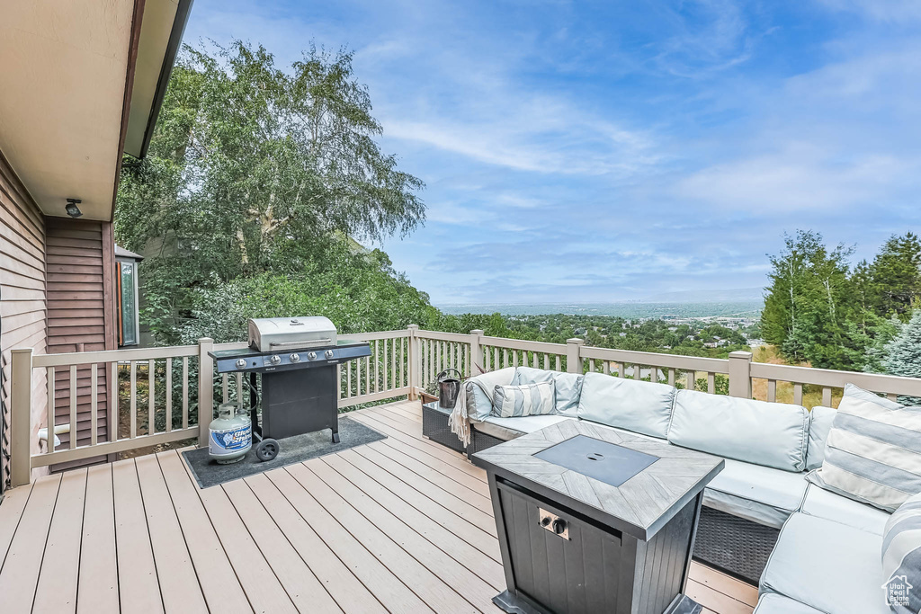 Deck with outdoor lounge area and a grill