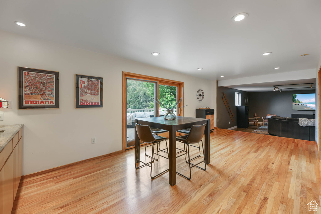 Dining space with light wood-type flooring and recessed lighting