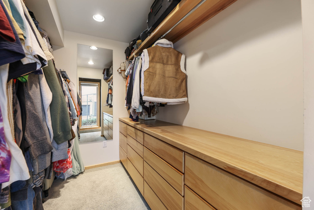 Walk in closet featuring light carpet