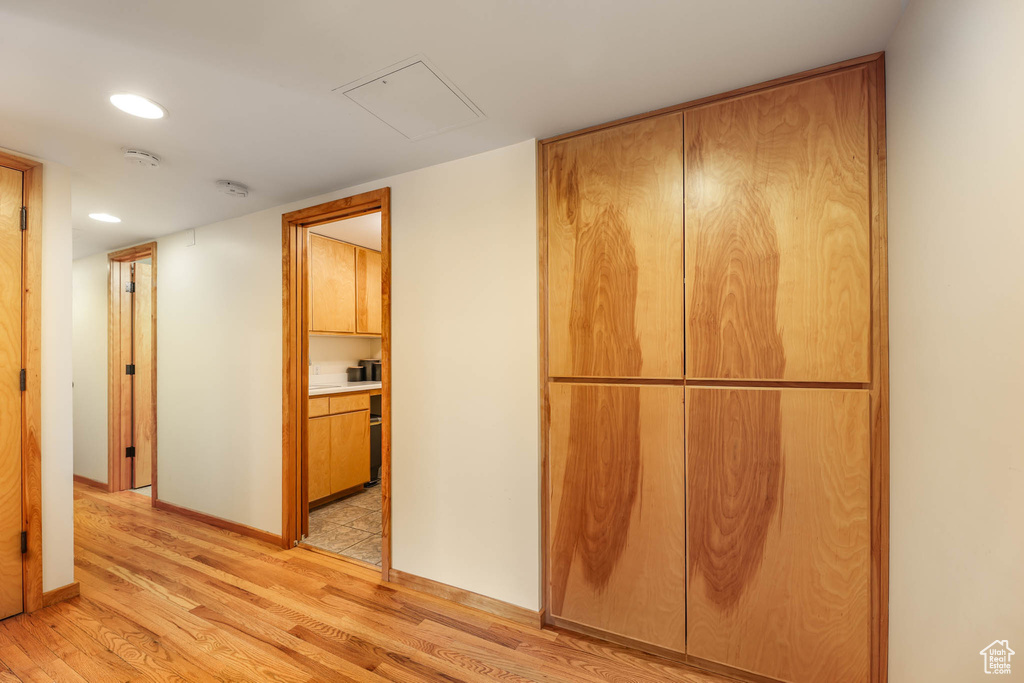 Hallway featuring light wood-type flooring and recessed lighting