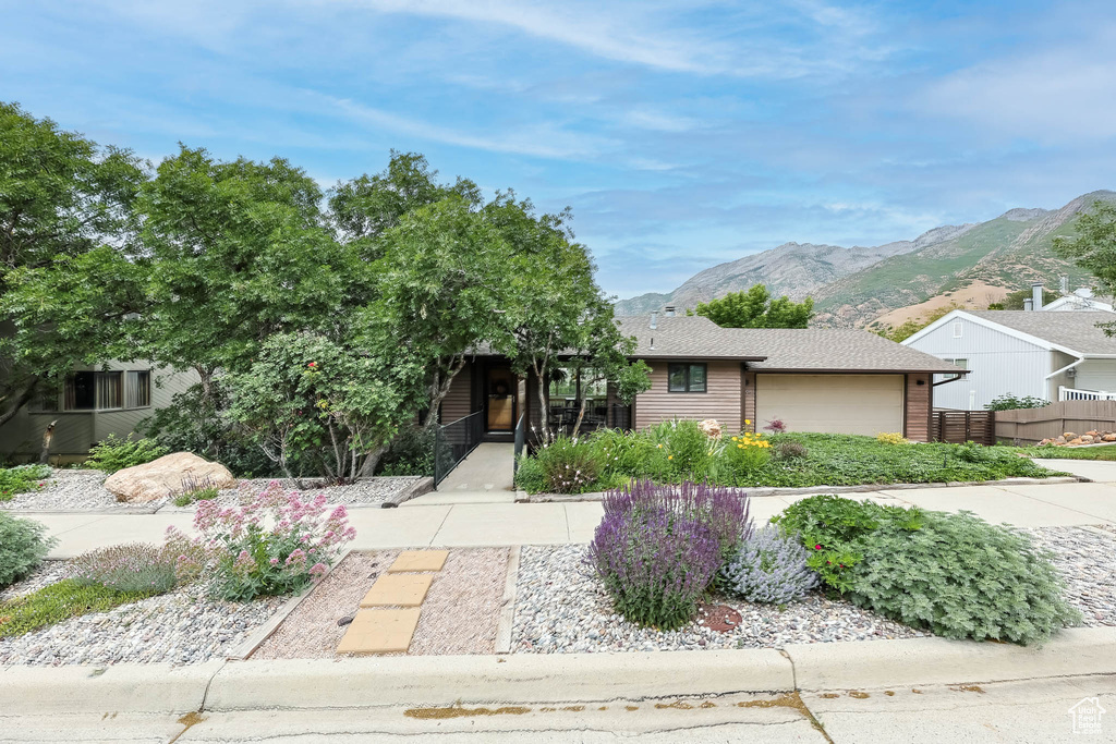 View of front of property with a mountain view and an attached garage