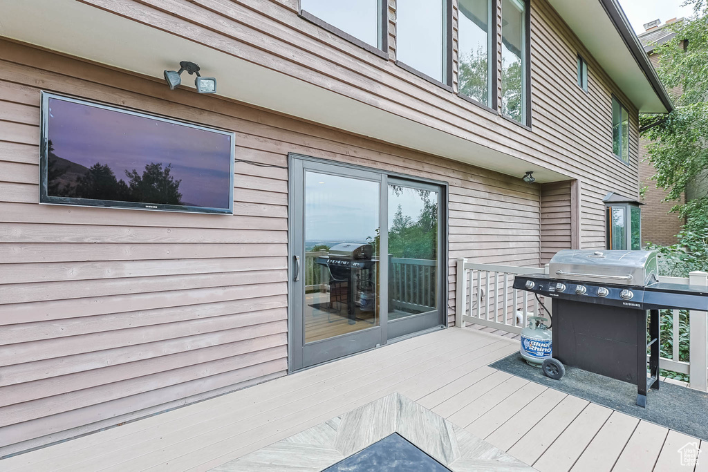 Wooden terrace featuring grilling area