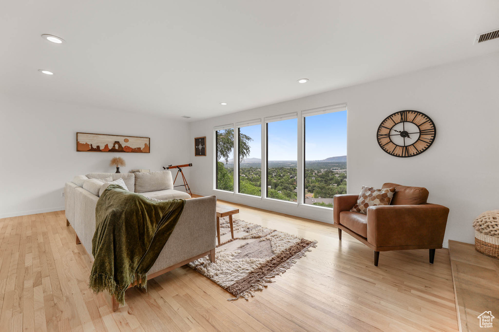 Living room with light wood-style floors and recessed lighting