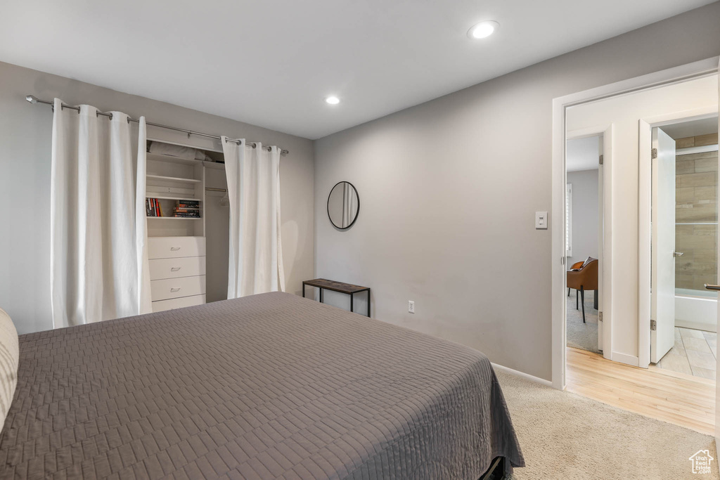 Bedroom featuring recessed lighting, light carpet, and connected bathroom