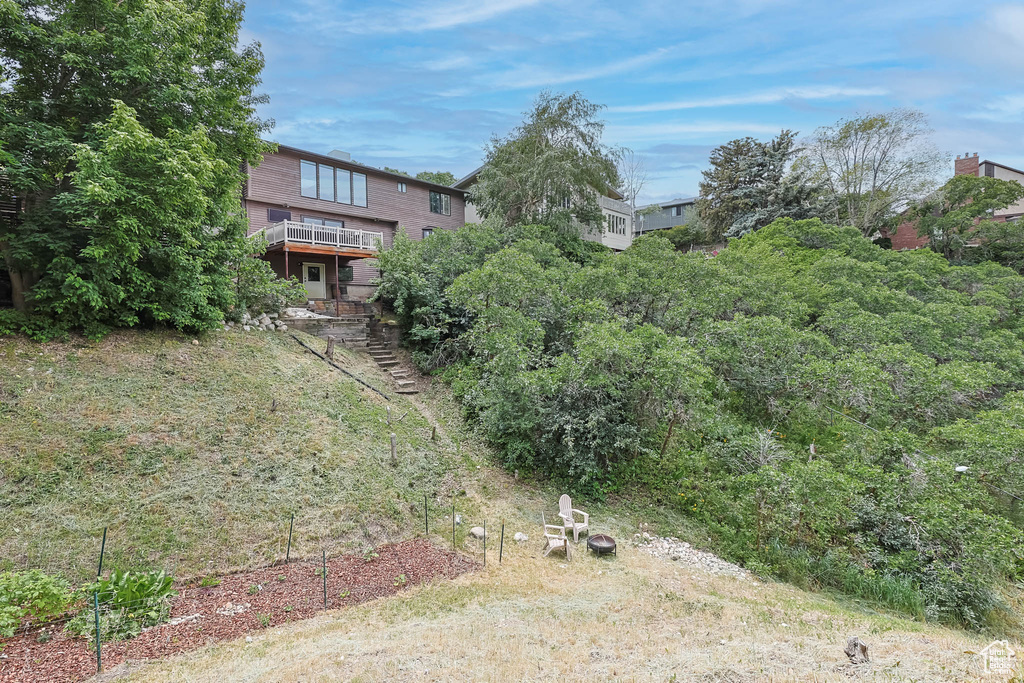 View of yard featuring stairs and a deck
