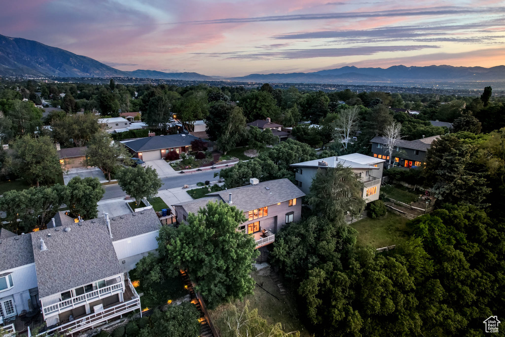 Aerial view of property and surrounding area featuring a mountainous background