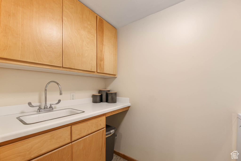 Kitchen featuring a sink and light countertops