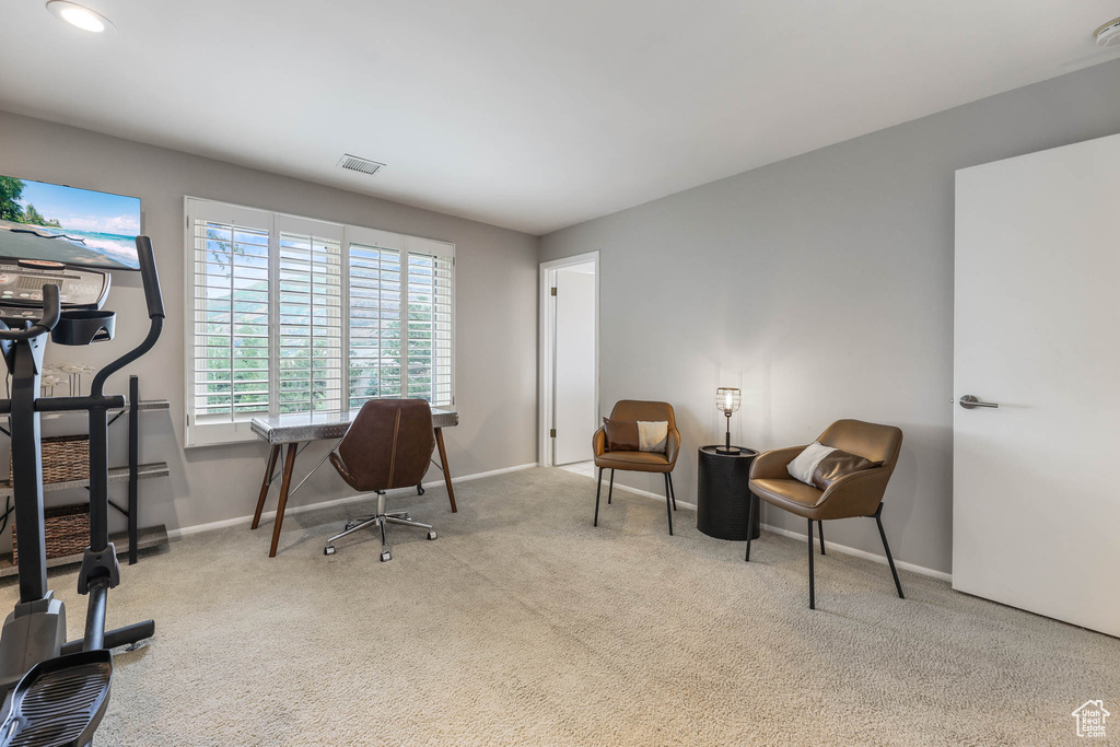 Carpeted office space featuring baseboards
