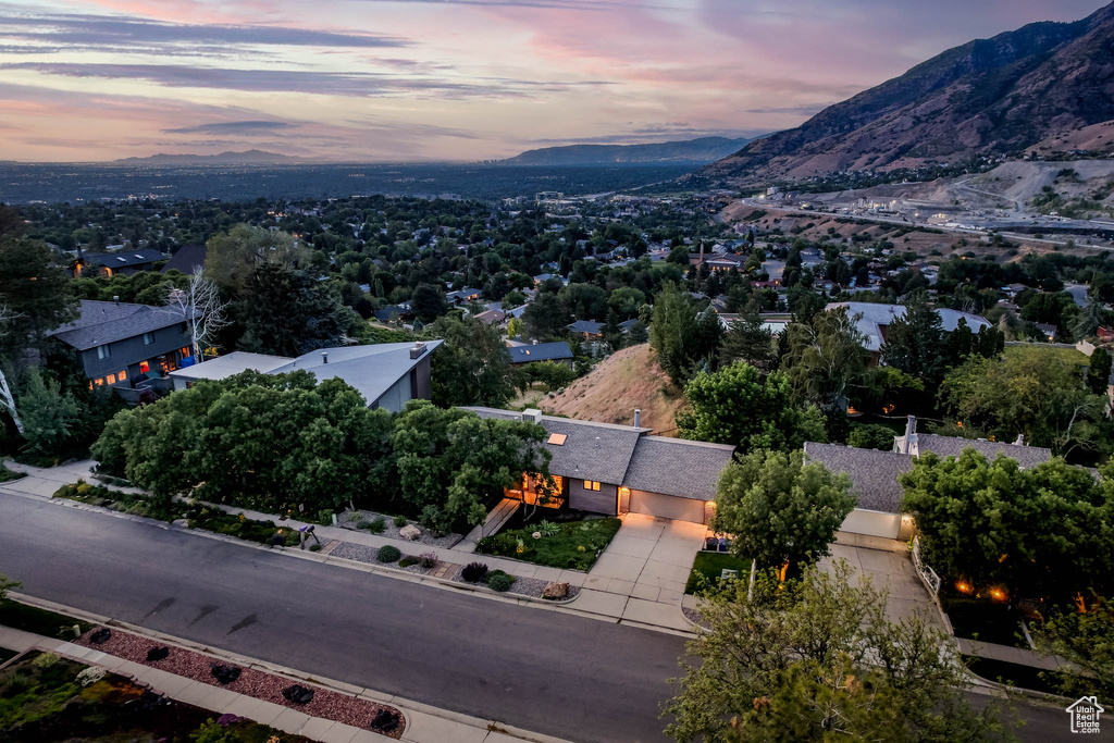 Aerial view of property and surrounding area featuring a mountainous background