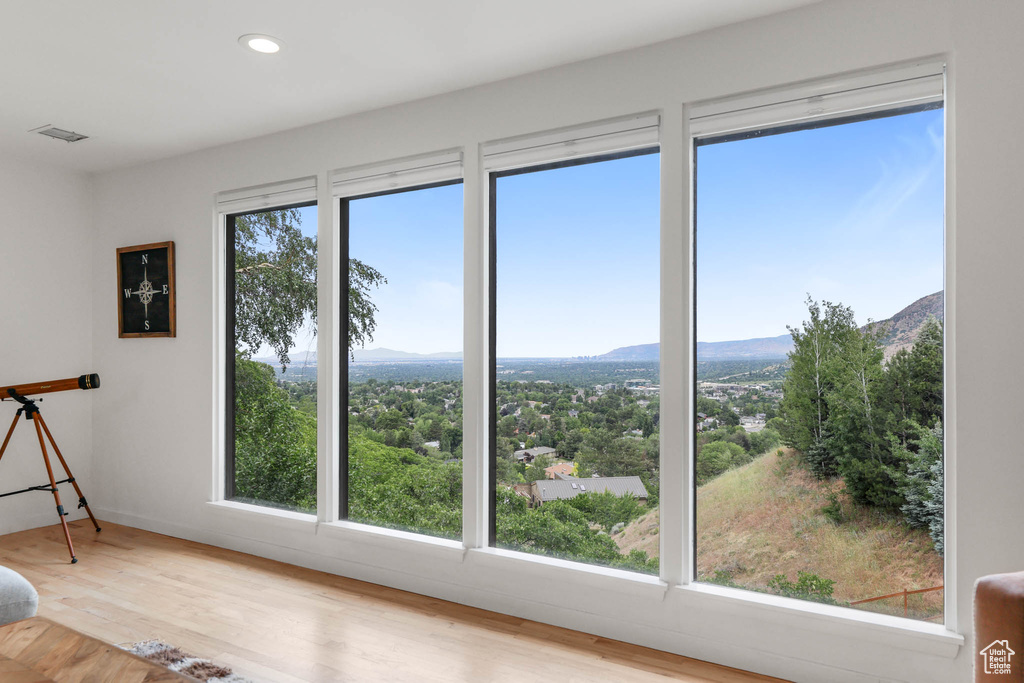 Unfurnished room with wood finished floors, recessed lighting, and a mountain view
