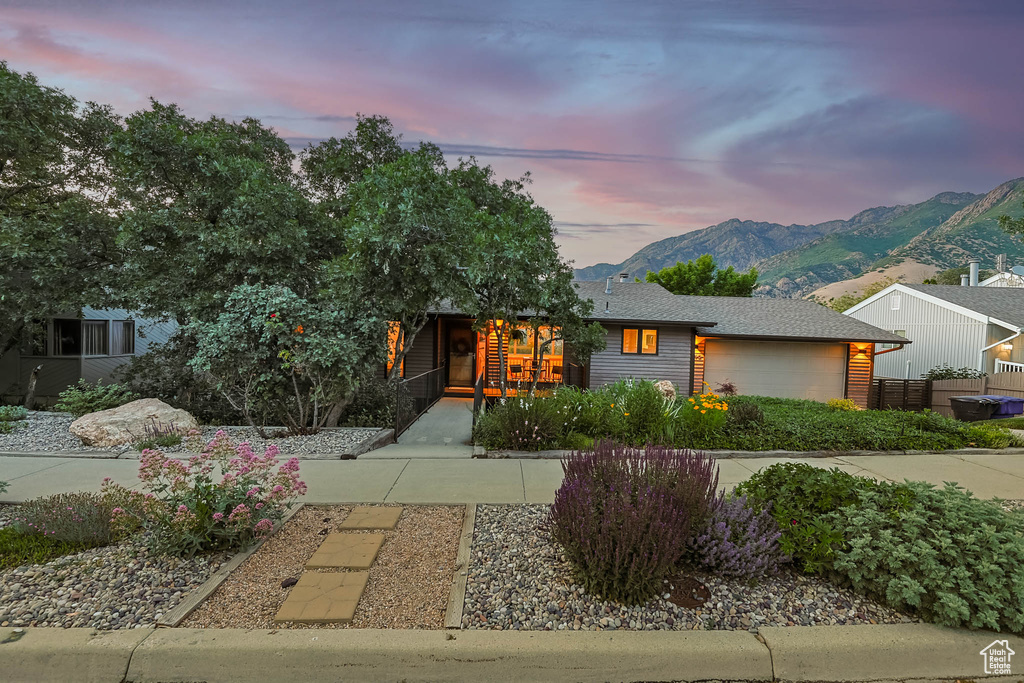 View of front of house with a mountain view and an attached garage