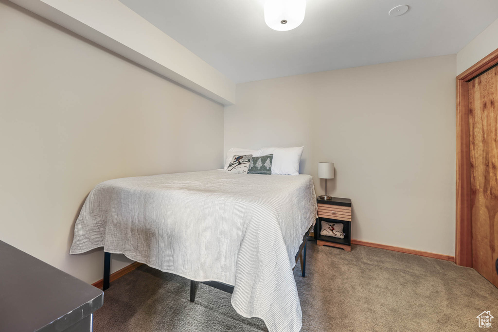 Bedroom featuring carpet and baseboards