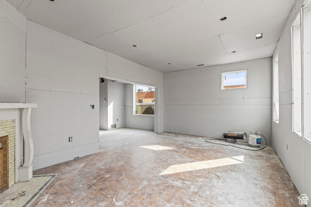 Unfurnished living room with a brick fireplace