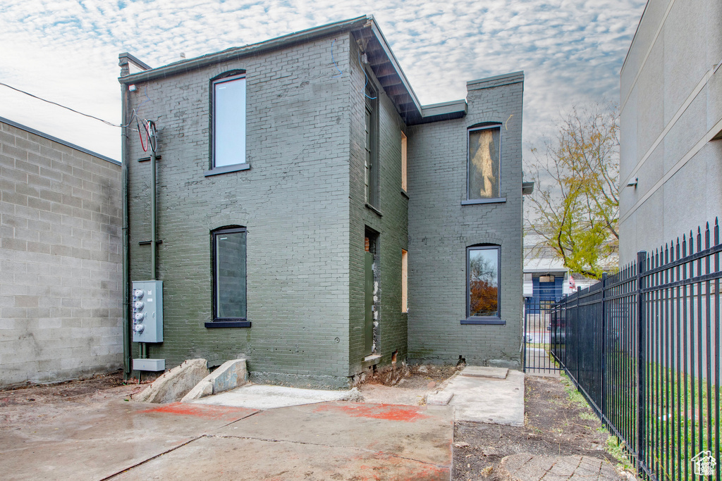 Back of house featuring brick siding