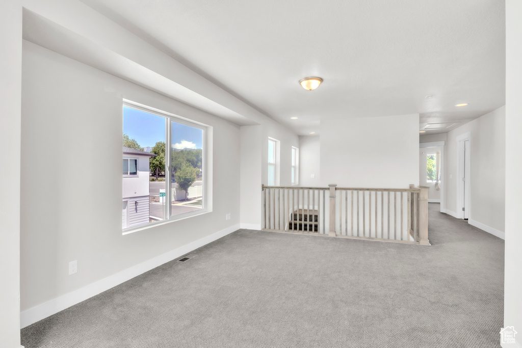 Carpeted spare room featuring recessed lighting