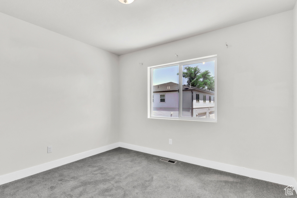 Empty room with baseboards and carpet floors