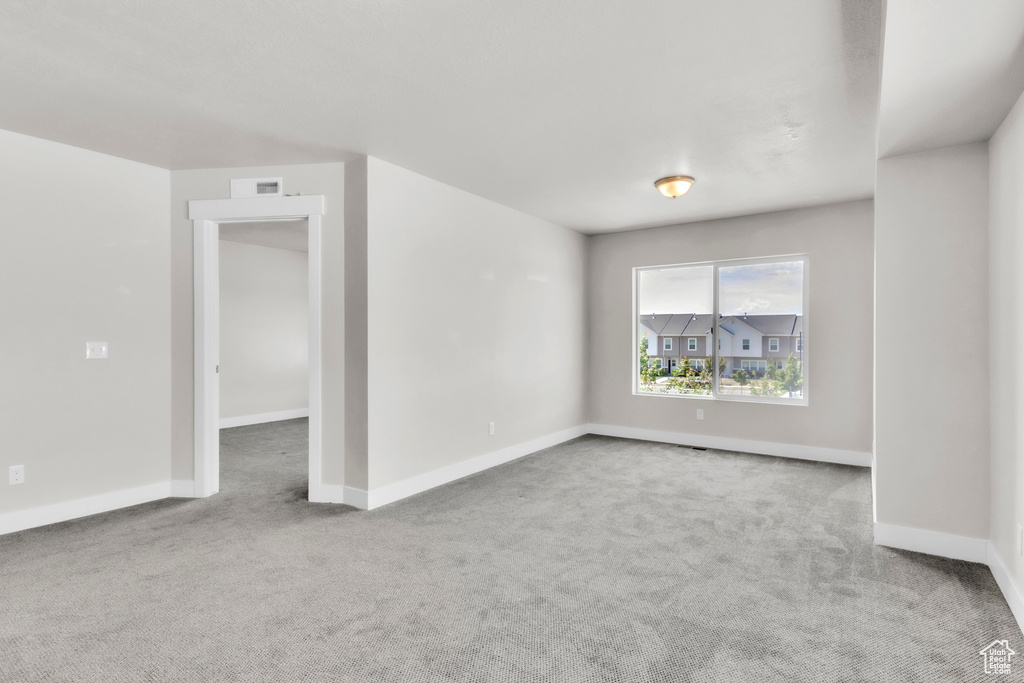 Carpeted spare room with baseboards