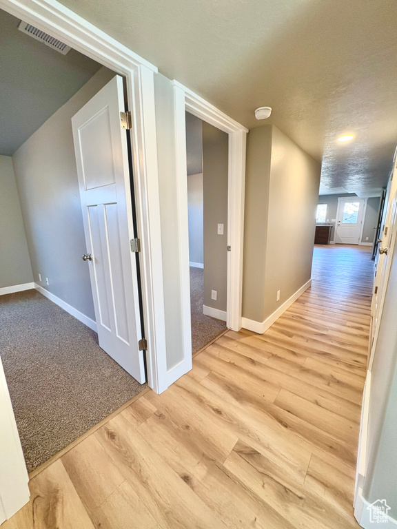 Hall featuring wood finished floors and baseboards