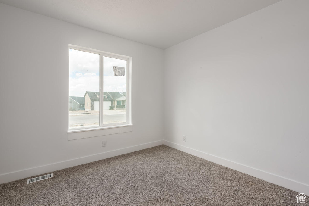 Unfurnished room with carpet floors and baseboards