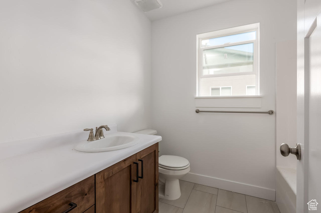 Full bathroom with vanity, tile patterned floors, and a bathtub