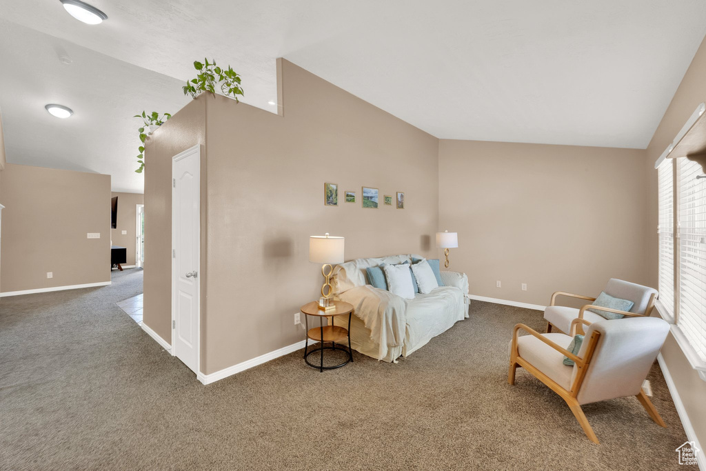Living room with lofted ceiling and carpet