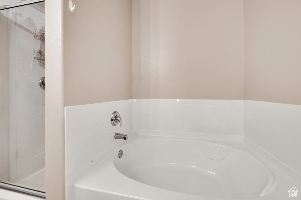 Bathroom featuring a bath and a shower
