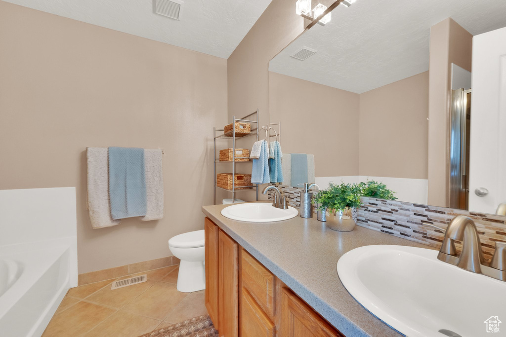 Full bathroom with a bath, tile patterned floors, double vanity, a shower stall, and decorative backsplash