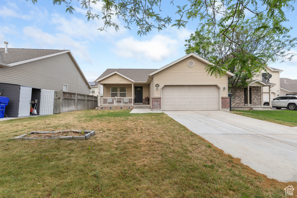 Ranch-style house with a garage, covered porch, driveway, brick siding, and roof with shingles