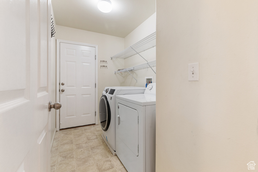 Laundry room featuring washer and clothes dryer