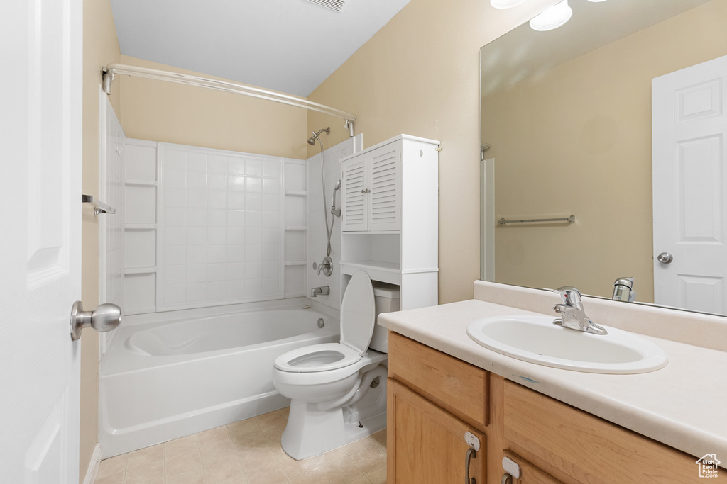 Full bath with tile patterned flooring, vanity, and shower / washtub combination