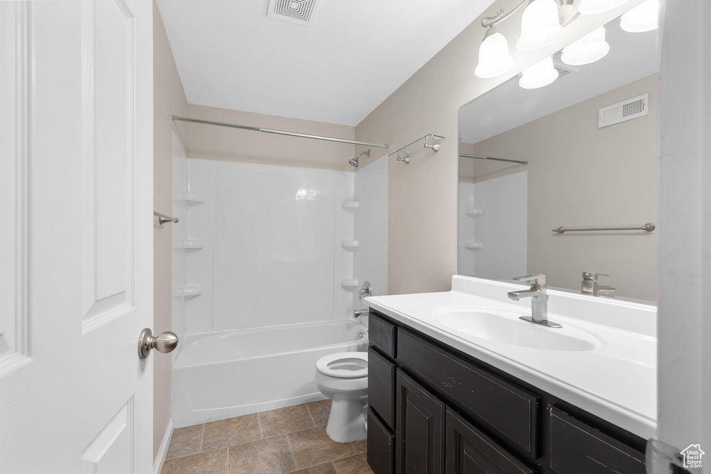 Full bath with vanity, washtub / shower combination, and stone finish floors