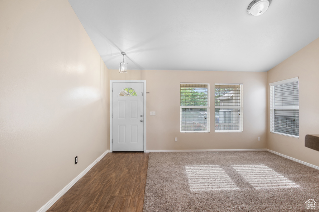 Foyer entrance featuring vaulted ceiling and wood finished floors