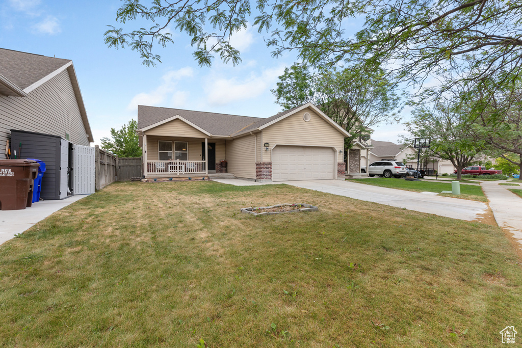 Ranch-style house featuring a porch, concrete driveway, a garage, roof with shingles, and brick siding