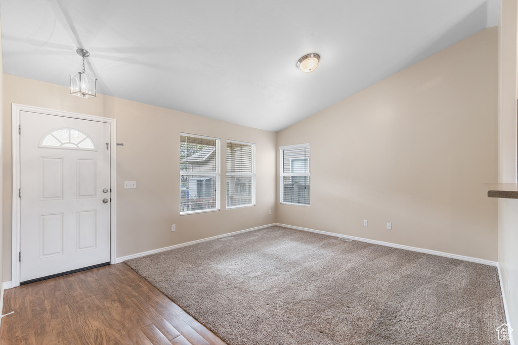 Entryway featuring lofted ceiling and wood finished floors