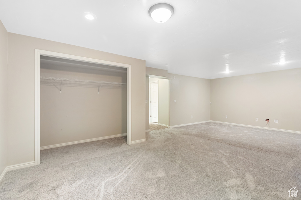 Unfurnished bedroom featuring carpet and a closet