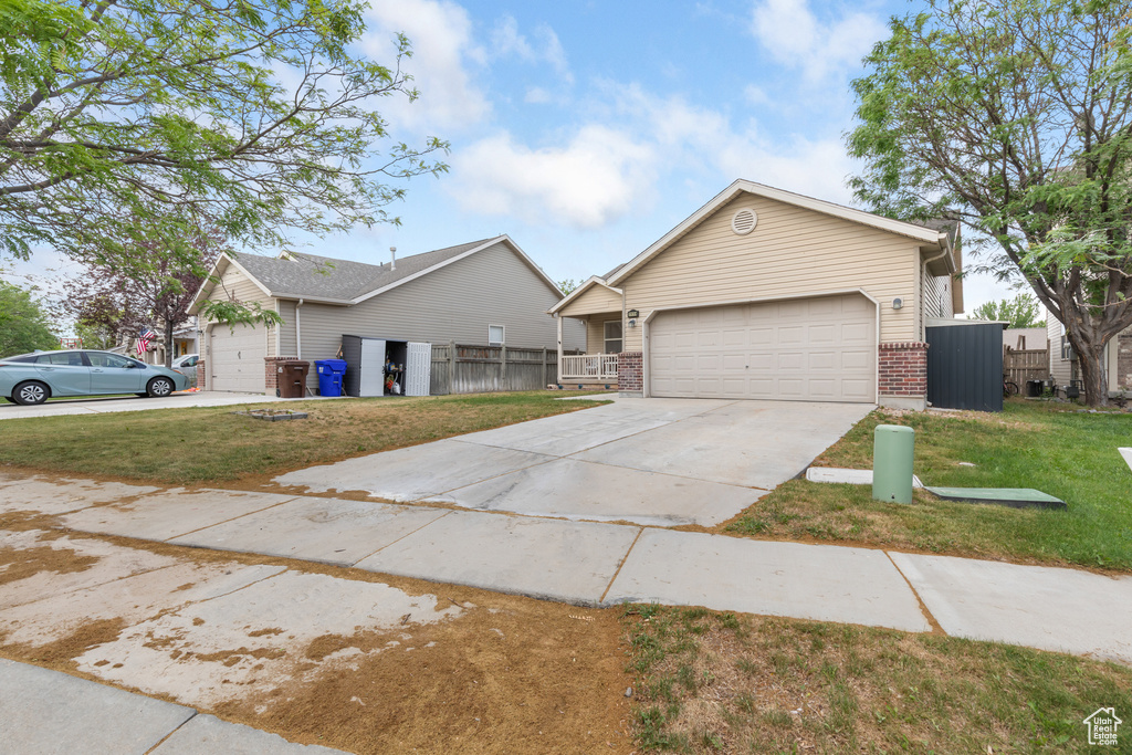 View of front of home featuring brick siding, concrete driveway, and an attached garage