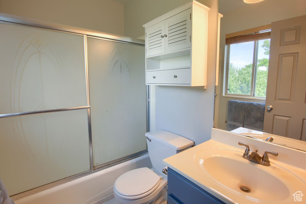 Bathroom with vanity and shower / bath combination with glass door