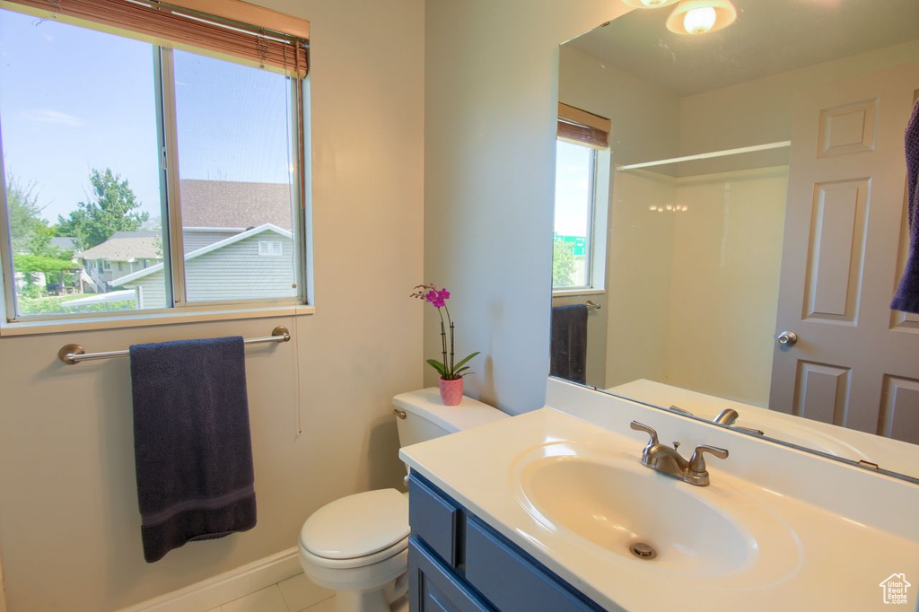 Full bathroom with vanity, tile patterned floors, and a shower