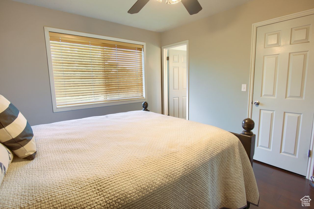 Bedroom with dark wood-style flooring and a ceiling fan
