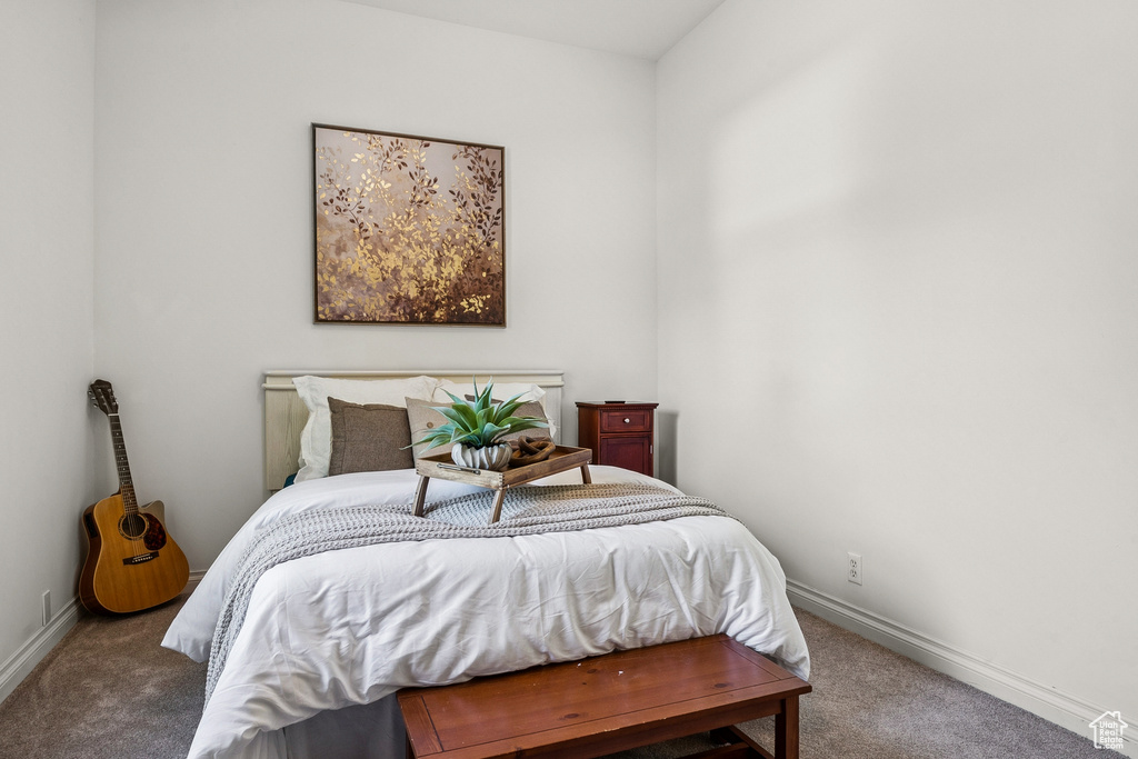 Carpeted bedroom featuring baseboards