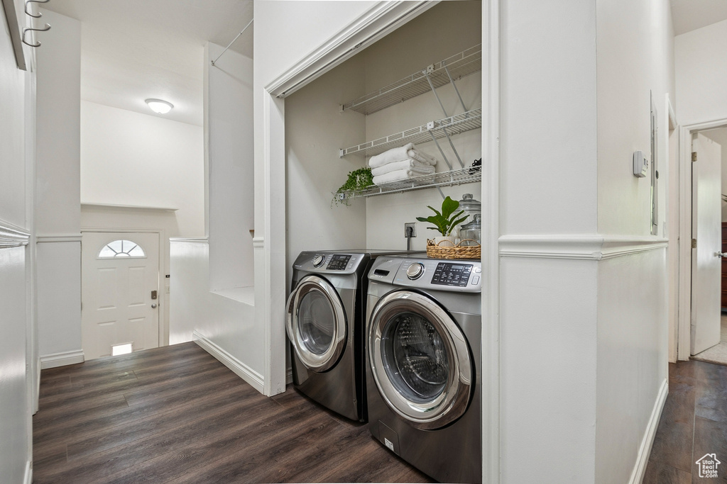 Laundry area with dark wood-style floors and independent washer and dryer
