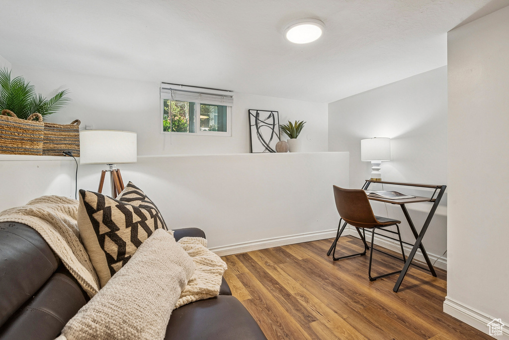 Living area with wood finished floors and baseboards