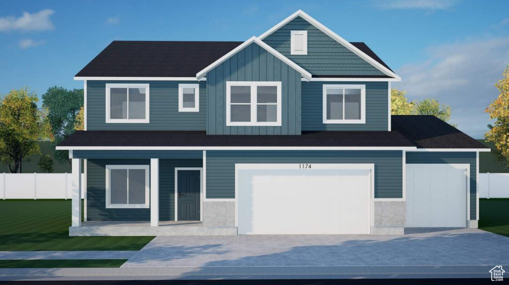 View of front facade with board and batten siding, an attached garage, and driveway