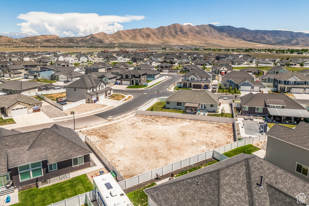 Aerial perspective of suburban area featuring a mountain backdrop