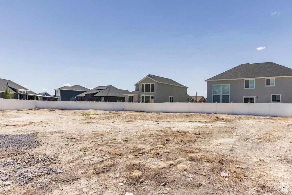 Rear view of property featuring stucco siding and a residential view