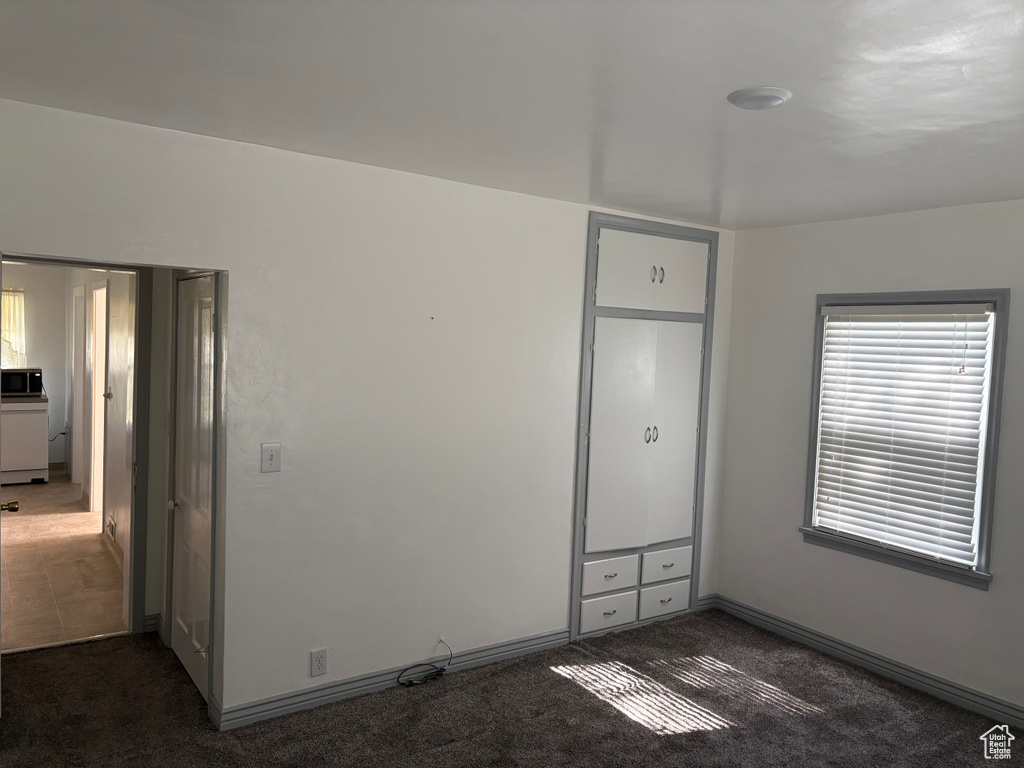 Unfurnished bedroom with carpet flooring