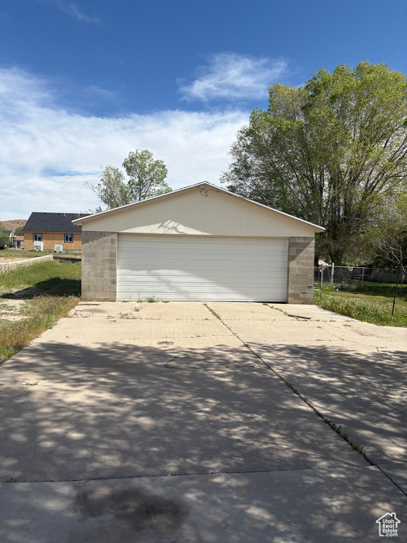 View of property exterior featuring an outbuilding and a garage